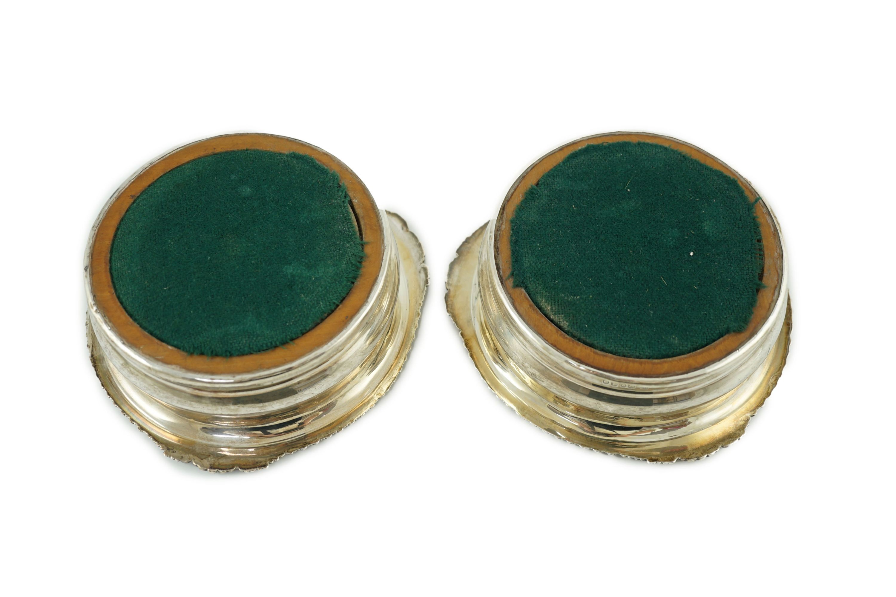 A pair of George IV silver wine coasters by Benjamin Smith III
